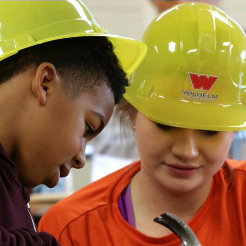 mentor and mentee in hard hats